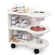 a white shelf with many different types of medical supplies on it's wheels and shelves