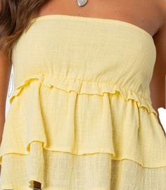 Spring Vacation Bandeau Tops, Summer Bandeau Tube Top For Day Out, Summer Solid Color Strapless Tops, Solid Strapless Summer Tops, Summer Beach Ruffled Tube Top, Spring Beach Bandeau Top, Spring Bandeau Top For Beach, Summer Beach Tube Top With Ruffles, Summer Style Yellow Tube Top For Vacation