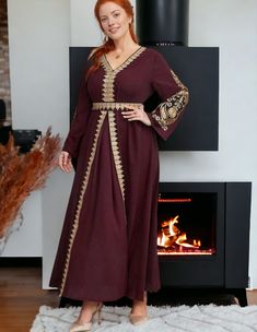 Experience the opulence and grace of our Elegant Maroon Embroidered Dress, intricately embellished with shimmering gold embroidery on the sleeves and front panel. The exquisite Guipure lace detailing adds a touch of sophistication, while the delicately embroidered waist and back tie exude elegance. Made from luxurious 100% polyester, it offers unrivaled comfort and style. Available in sizes 0XL - 4XL (US 12 - 20). **PLEASE NOTE**This item requires our "formal dresses" shipping option due to its Long Sleeve Embellished Embroidered Dress For Eid, Embroidered Long Sleeve Dress For Eid, Elegant Gold Dress With Resham Embroidery, Festive V-neck Embroidered Embellished Dress, Long Sleeve Embellished Kaftan For Festive Occasions, Embellished Long Sleeve Kaftan For Festive Occasions, Traditional Long Sleeve Embellished Dresses, Long Sleeve Embellished Festive Kaftan, Embellished Long Sleeve Festive Kaftan