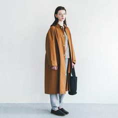 The Riddhi coat has a roomy fit with shell buttons down the front and a pointed collar. With a dropped shoulder, long sleeves that button at the cuff, and two flap button closure pockets at the front. A deep back yoke and a kick pleat at the back hem add tailored details. 100% cotton-medium weight poplin. 44" length x 52" chest x 30" neck to sleeveMachine wash gentle. Dry cool or line-dry.Fog Linen Work is a Japanese lifestyle brand founded by Yumiko Sekine during the late 1990s. With an international following, Fog is well known for its range of linen housewares + clothing, as well as its developing collection of wood, brass, and metal objects for everyday living. They endeavor to design and distribute an honest, beautiful, and long-lasting product. Oversized Outerwear With Button Cuffs For Daywear, Oversized Collared Outerwear With Button Closure, Long Cotton Outerwear With Buttons, Oversized Outerwear With Lapel Collar And Buttons, Oversized Outerwear With Buttons And Lapel Collar, Oversized Outerwear With Stand Collar And Button Closure, Stand Collar Outerwear With Buttoned Pockets For Work, Workwear Outerwear With Buttoned Pockets And Stand Collar, Oversized Collared Outerwear With Button Cuffs