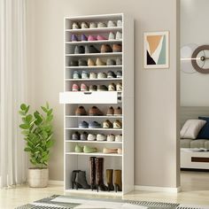 there is a shoe rack with many pairs of shoes on it in the living room