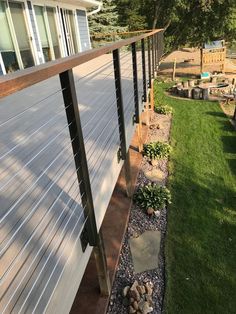 the side of a house with grass and rocks