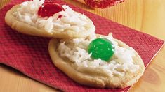 two cookies with gummy bears on top of each one sitting on a red napkin