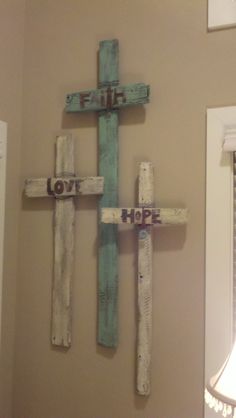 a wooden cross with the words love and hope painted on it is displayed in an instagram