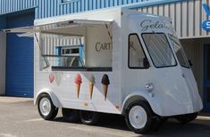 an ice cream truck parked in front of a building