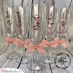 five wine glasses with pink bows on them