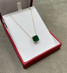 Featured here is a 4.18-carat stunning, Asscher cut emerald necklace in 14K yellow gold. Displayed in the center is a dark green emerald with very good eye clarity, accented by a simple double-prong gold mount, allowing for the emerald to be shown in full view. The earth mined emerald has a desirable lush green color with excellent qualities. An 18 inch is attached to the emerald pendant. This necklace is ideal for everyday use and is the perfect accessory for any outfit. Total Carat Weight: 4.1 Formal Emerald Baguette Cut Necklace, Formal Emerald-cut Birthstone Necklace, Formal Emerald Cut Birthstone Necklace, 14k Gold Emerald Cut Emerald Necklace, Fine Jewelry Emerald Cut Emerald Necklace For Formal Events, Formal Green Emerald Necklace In 14k Gold, Classic Emerald Necklace With Prong Setting As Gift, Gold Emerald-cut Necklace With Diamond Details, Yellow Gold Emerald Cut Solitaire Necklace For Anniversary