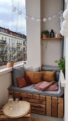 a couch sitting on top of a wooden table next to a window filled with lots of windows