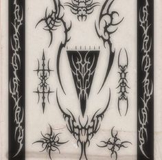 an artistic design on the back of a white and black tile with intricate designs around it