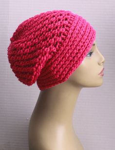 a mannequin head wearing a pink knitted hat