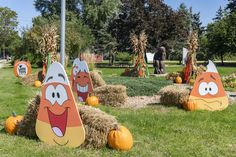 pumpkins and hay bales with cartoon faces on them