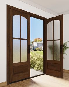 an open wooden door leading to a white house