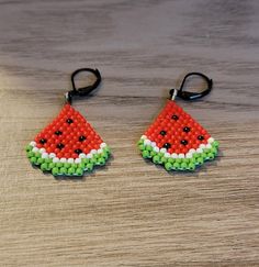 a pair of watermelon seed beaded earrings