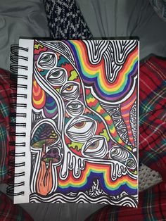 a notebook with an abstract drawing on it