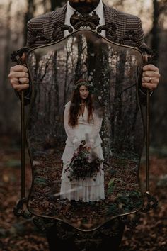 a man and woman standing in front of a mirror