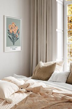 a bed with pillows and blankets in front of a window