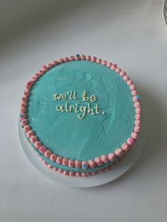 there is a cake that says tell be alright on the frosting and icing