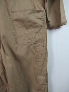 "Vintage 1950s workwear coveralls. Made of khaki tan herringbone twill cotton. Has several pockets, zip front and donut hole metal buttons with Union Made. No label. Size large. Actual measurements are: 49\" at the chest 43\" at the waist 20.5\" shoulder seam to shoulder seam 23.5\" shoulder seam to cuff 25\" inseam In good condition but the legs have been hemmed 3.5\"." Khaki Overalls With Pockets For Fall, Fall Khaki Overalls With Pockets, Vintage Brown Cotton Overalls, Vintage Cotton Overalls With Side Pockets, Vintage Overalls For Fall Workwear, Khaki Long Sleeve Utility Overalls, Vintage Workwear Overalls With Pockets, 1950s Workwear, Vintage Coveralls