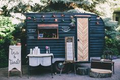 an old trailer is decorated with lights and decorations