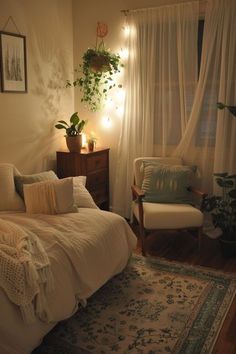 a bedroom with a bed, chair and plants in the corner on the wall next to the window