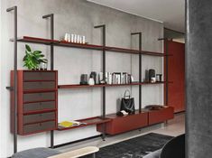 a living room filled with furniture next to a wall mounted book shelf and potted plant