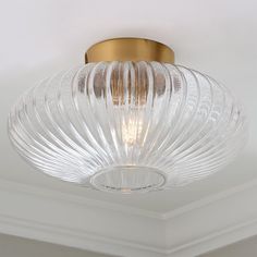 a glass light fixture hanging from the ceiling