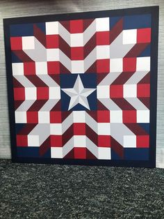 a quilt made to look like an american flag with stars and stripes on the center