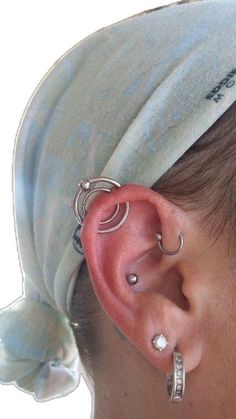 a close up of a person with ear piercings