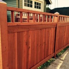 a wooden fence in front of a house