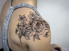 a woman's shoulder with flowers on it