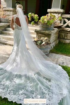 a woman in a wedding dress is standing outside