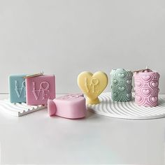 three soap bars are sitting on a plate with the word love spelled in small letters