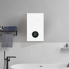 a white bath tub sitting next to a wall mounted clock