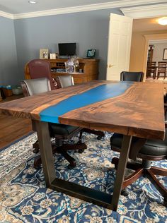 a wooden table sitting on top of a blue rug