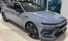 a grey car is on display in a showroom