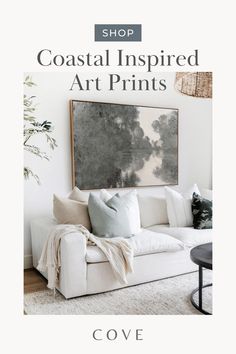 a white couch sitting in front of a painting on the wall with text that reads coastal inspired art prints