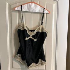 Has Never Been Worn, But I No Longer Have The Tags. Has Been Kept In A Protective Storage Tote For Over A Decade. Made Of 93% Silk And 7 % Spandex. Has Adjustable Straps. Express Design Studio Size Large Black Coquette Sleeveless Camisole, Black Sleeveless Coquette Camisole, Black Sleeveless Coquette Top, Black Tops With Built-in Bra For Daywear, Black Spaghetti Strap Tops For Daywear, Black Coquette Top With Built-in Bra, Black Fitted Camisole For Daywear, Black Tops With Built-in Bra Coquette Style, Fitted Black Camisole For Daywear