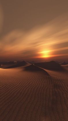 the sun is setting over some sand dunes