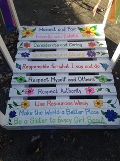 a set of four wooden signs with flowers on them