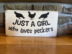 a wooden sign that says just a girl who loves peckers