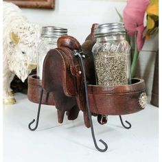 an elephant spice rack with two jars on it