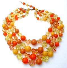 Cheap Orange Beaded Necklace With Colorful Beads, Luxury Vintage Orange Necklace, Vintage Orange Necklace With Colorful Beads, Vintage Orange Round Beads Necklace, Vintage Yellow Necklace With Colorful Beads, Vintage Orange Round Bead Necklace, Vintage Orange Necklace With Round Beads, Orange Costume Jewelry Beaded Necklace, Vintage Orange Necklace With Large Beads