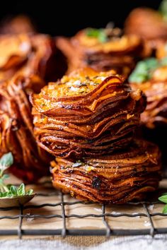 stack of baked sweet potato chips on cooling rack with mint sprig in foreground