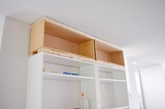 an empty shelf in the corner of a room that is being built into the wall