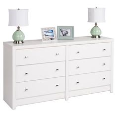 a white dresser with two lamps on top