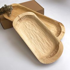 two wooden trays sitting next to each other on top of a white countertop