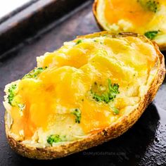 two baked potatoes with cheese and broccoli in them