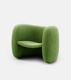 a green chair sitting on top of a white floor