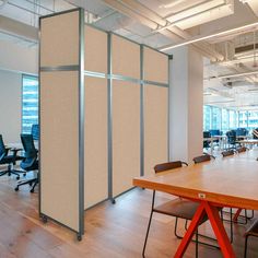 an empty conference room with partitions and chairs