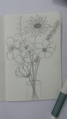 a drawing of flowers in a vase on a table next to a pen and paper